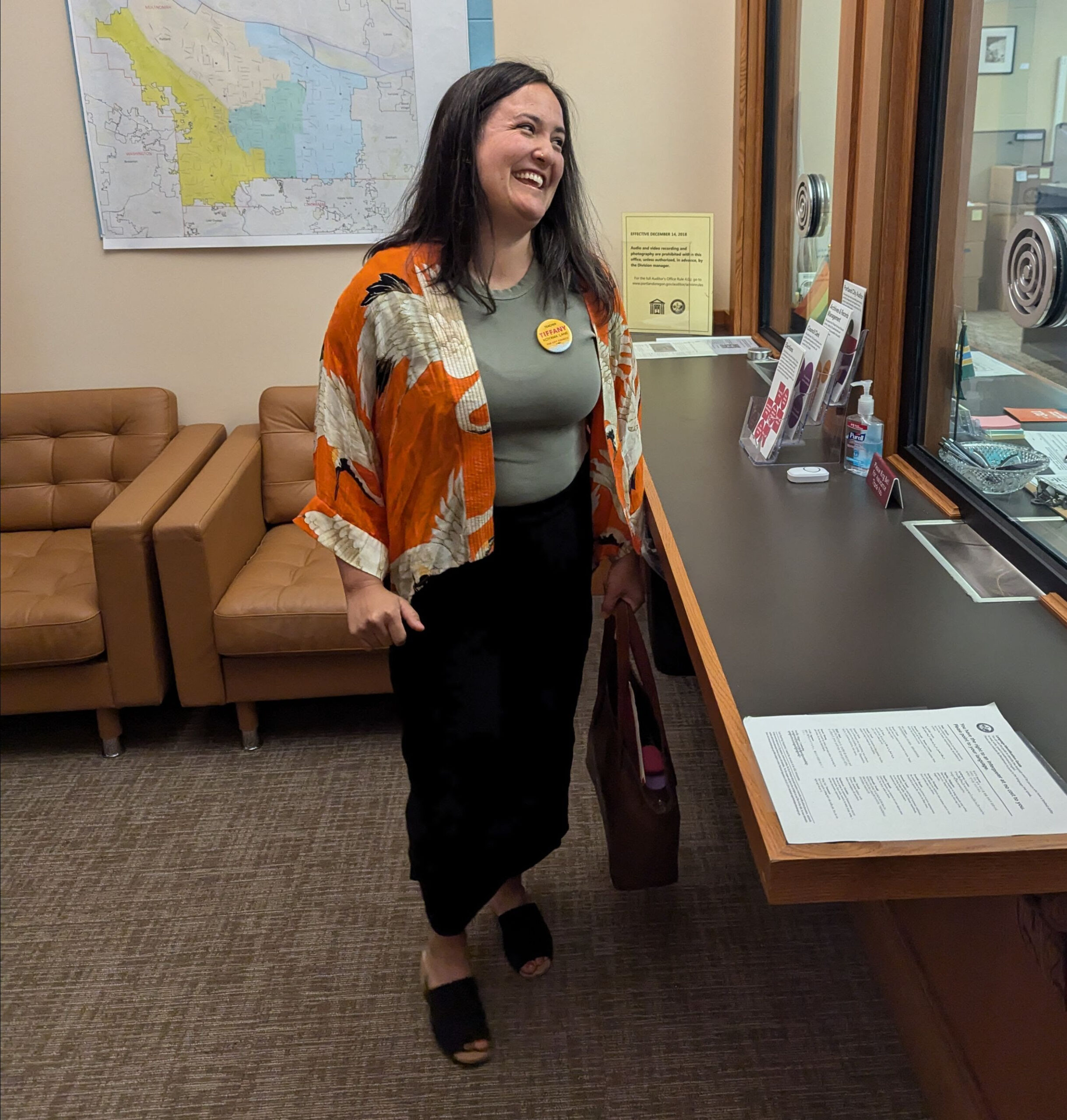 Teacher Tfifany standing in front of a counter speaking with a city clerk